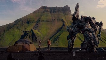 Movie still from “Noah” (2014), directed by Darren Aronofsky – Two people standing in front of a rock formation; Extreme Wide shot, Low angle