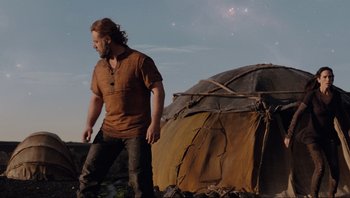 Movie still from “Noah” (2014), directed by Darren Aronofsky – A man walking near a tent on the beach; Medium shot, Low angle