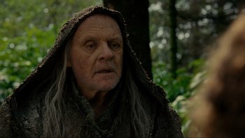 Movie still from “Noah” (2014), directed by Darren Aronofsky – An old man with a long white beard wearing a hood; Close Up shot, Low angle