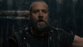 Movie still from “Noah” (2014), directed by Darren Aronofsky – A man with a beard and a wet jacket on; Close Up shot, Over the shoulder angle