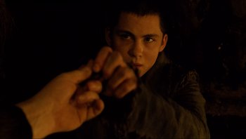 Movie still from “Noah” (2014), directed by Darren Aronofsky – A young man holding something in his hand; Close Up shot, Over the shoulder angle