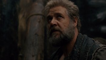 Movie still from “Noah” (2014), directed by Darren Aronofsky – A man with a long beard looking to his left; Close Up shot, Low angle