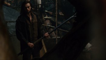 Movie still from “Noah” (2014), directed by Darren Aronofsky – A man holding a sword while standing next to another man; Medium shot, Low angle