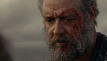 Movie still from “Noah” (2014), directed by Darren Aronofsky – An old man with a beard and a red scar on his face; Close Up shot, Low angle