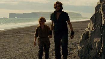 Movie still from “Noah” (2014), directed by Darren Aronofsky – A man and a woman walking on the beach; Medium shot, Low angle