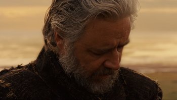 Movie still from “Noah” (2014), directed by Darren Aronofsky – An older man with grey hair looking down at the ground; Close Up shot, Over the shoulder angle
