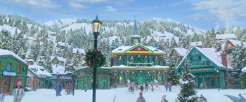 Movie still from “Noelle” (2019), directed by Marc Lawrence – A painting of a christmas village with a clock tower; Extreme Wide shot, High angle