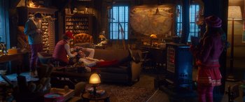 Movie still from “Noelle” (2019), directed by Marc Lawrence – A man laying on top of a couch in a living room; Wide shot, High angle