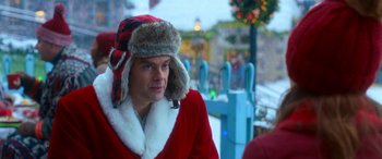 Movie still from “Noelle” (2019), directed by Marc Lawrence – A man wearing a red coat and a fur hat; Close Up shot, Over the shoulder angle