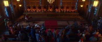 Movie still from “Noelle” (2019), directed by Marc Lawrence – A group of people standing in front of a red carpet; Extreme Wide shot, High angle