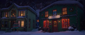 Movie still from “Noelle” (2019), directed by Marc Lawrence – A green building with christmas lights on it's windows; Extreme Wide shot, Low angle