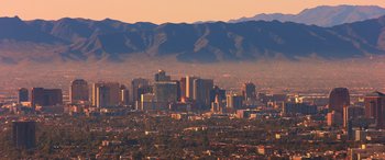 Movie still from “Noelle” (2019), directed by Marc Lawrence – A view of a large city with mountains in the background; Extreme Wide shot, High angle