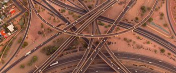 Movie still from “Noelle” (2019), directed by Marc Lawrence – An aerial view of an intersection in the middle of the desert; Extreme Wide shot, Overhead angle