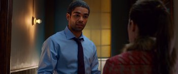 Movie still from “Noelle” (2019), directed by Marc Lawrence – A man wearing a blue shirt and a purple tie; Medium shot, Over the shoulder angle