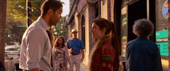 Movie still from “Noelle” (2019), directed by Marc Lawrence – A group of people walking down a street; Medium shot, Over the shoulder angle