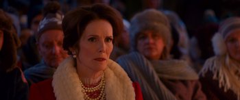 Movie still from “Noelle” (2019), directed by Marc Lawrence – A woman in a red dress and a woman in a white fur coat; Close Up shot, Over the shoulder angle