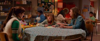 Movie still from “Noelle” (2019), directed by Marc Lawrence – A group of people sitting around a table; Medium shot, Over the shoulder angle