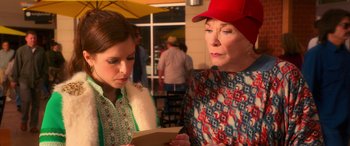 Movie still from “Noelle” (2019), directed by Marc Lawrence – Two women looking at a piece of paper; Medium shot, Over the shoulder angle