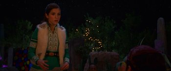 Movie still from “Noelle” (2019), directed by Marc Lawrence – A woman standing in front of a tree at night; Medium shot, Over the shoulder angle