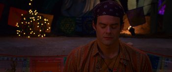 Movie still from “Noelle” (2019), directed by Marc Lawrence – A man with a head band is sitting down; Close Up shot, High angle