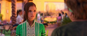 Movie still from “Noelle” (2019), directed by Marc Lawrence – A woman in a green dress is looking at the camera; Close Up shot, Over the shoulder angle