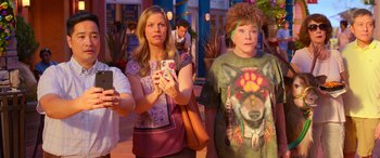 Movie still from “Noelle” (2019), directed by Marc Lawrence – Two women are standing next to each other holding cell phones in their hands; Medium shot, Over the shoulder angle