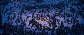 Movie still from “Noelle” (2019), directed by Marc Lawrence – An aerial view of a snow - covered village at night; Extreme Wide shot, High angle