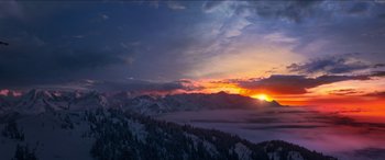 Movie still from “Noelle” (2019), directed by Marc Lawrence – The sun is setting over a mountain range; Extreme Wide shot, Low angle