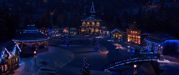 Movie still from “Noelle” (2019), directed by Marc Lawrence – Christmas trees lit up at night in front of a house; Extreme Wide shot, High angle