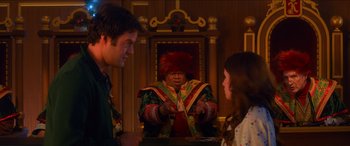 Movie still from “Noelle” (2019), directed by Marc Lawrence – A man and two women standing in front of a table; Medium shot, Over the shoulder angle