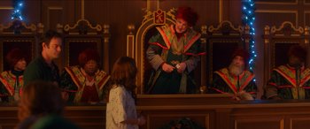 Movie still from “Noelle” (2019), directed by Marc Lawrence – A woman dressed as a clown standing in front of a mirror; Medium shot, Over the shoulder angle