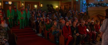 Movie still from “Noelle” (2019), directed by Marc Lawrence – A large group of people sitting in a room; Extreme Wide shot, High angle