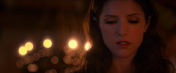 Movie still from “Noelle” (2019), directed by Marc Lawrence – A woman's face in front of lights; Close Up shot, Overhead angle