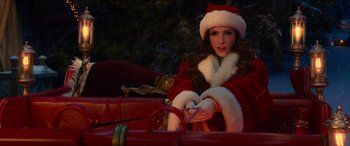 Movie still from “Noelle” (2019), directed by Marc Lawrence – A woman sitting in the back of a red sleigh; Medium shot, Over the shoulder angle