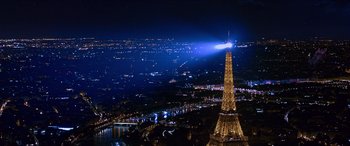 Movie still from “Noelle” (2019), directed by Marc Lawrence – The eiffel tower is lit up at night in paris; Extreme Wide shot, High angle