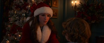 Movie still from “Noelle” (2019), directed by Marc Lawrence – A woman wearing a santa clause hat talking to another woman; Close Up shot, Over the shoulder angle