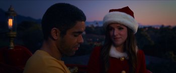 Movie still from “Noelle” (2019), directed by Marc Lawrence – A man and a woman wearing a santa clause hat; Close Up shot, Over the shoulder angle