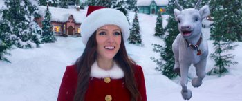 Movie still from “Noelle” (2019), directed by Marc Lawrence – A woman wearing a santa clause outfit in the snow; Close Up shot, Overhead angle