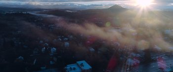 Movie still from “Notorious Nick” (2021), directed by Aaron Leong – A view of a city from a plane window; Extreme Wide shot, Low angle