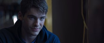 Movie still from “Notorious Nick” (2021), directed by Aaron Leong – A young man with blue eyes is looking at the camera; Close Up shot, Over the shoulder angle