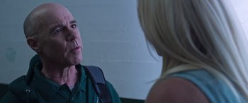 Movie still from “Notorious Nick” (2021), directed by Aaron Leong – A man and a woman are talking to each other; Close Up shot, Over the shoulder angle