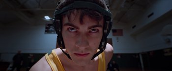 Movie still from “Notorious Nick” (2021), directed by Aaron Leong – A person with a helmet on; Close Up shot, Low angle