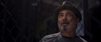 Movie still from “Notorious Nick” (2021), directed by Aaron Leong – A person wearing a hat; Close Up shot, Low angle