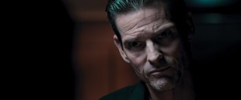 Movie still from “Notorious Nick” (2021), directed by Aaron Leong – A person with a beard; Close Up shot, Low angle
