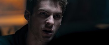 Movie still from “Notorious Nick” (2021), directed by Aaron Leong – A man's face in the dark; Extreme Close Up shot, Over the shoulder angle