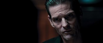 Movie still from “Notorious Nick” (2021), directed by Aaron Leong – A person with a beard; Close Up shot, Low angle