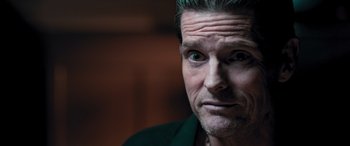 Movie still from “Notorious Nick” (2021), directed by Aaron Leong – A person with green hair; Close Up shot, Low angle