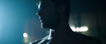 Movie still from “Notorious Nick” (2021), directed by Aaron Leong – A man's face in the dark; Extreme Close Up shot, Low angle