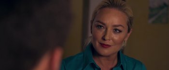 Movie still from “Notorious Nick” (2021), directed by Aaron Leong – A person wearing a blue shirt; Close Up shot, Over the shoulder angle