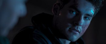 Movie still from “Notorious Nick” (2021), directed by Aaron Leong – A man's face in the dark; Extreme Close Up shot, Low angle